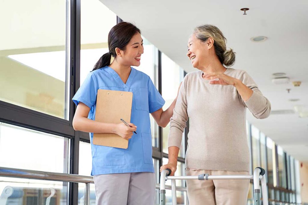 Family members review assisted living admission forms, legal papers, and a medication list at a kitchen table.