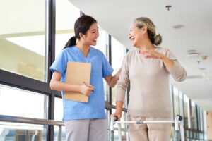 Family members review assisted living admission forms, legal papers, and a medication list at a kitchen table.